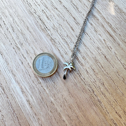 Größenvergleich der silbernen Palmenkette aus Edelstahl neben einer 1-Euro-Münze